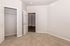 Inviting bedroom with plush carpet and ample closet space, exuding comfort and elegance.