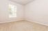 Bright and inviting empty room featuring plush carpeting and a large window with blinds, perfect for customizing your dream space.