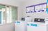 Bright and modern laundry room with state-of-the-art washing machines and large windows for natural light.
