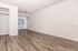 Inviting open-concept living area with wood-style flooring and cozy kitchen, perfect for modern city living.
