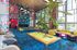 Vibrant modern lounge area with bold artwork, colorful furniture, and a pool table, perfect for social gatherings.