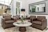 Elegantly designed living room featuring plush brown leather chairs, a chic marble coffee table, and a large decorative mirror that enhances natural light.