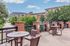 Charming riverside patio with modern seating, lush greenery, and scenic mountain views, perfect for relaxation.
