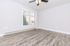 Bright, airy room with sleek wood flooring and a large window, perfect for a cozy living space.