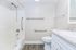 Modern bathroom featuring sleek fixtures, elegant granite countertop, and accessible design with grab bars.