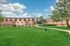 Charming apartment complex with vibrant surroundings and lush green lawns, perfect for comfortable living in a serene neighborhood.