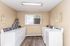 Bright and convenient laundry room featuring modern washers and dryers with ample space.