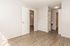 Bright and spacious room with elegant wood flooring and modern lighting, offering a welcoming atmosphere.