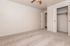 Spacious, light-filled room with fresh carpeting and dual closets, perfect for creative interior design.