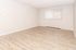 Inviting living space with elegant wood flooring, abundant natural light, and a cozy atmosphere.