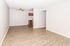 Inviting open-concept living space with elegant wood flooring and a cozy kitchen nook.