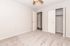 Bright, spacious bedroom with plush carpet, built-in closet, and ceiling fan, perfect for comfortable living.
