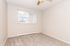 Bright and inviting room featuring soft carpet flooring, large window with vertical blinds, and warm neutral walls for a cozy atmosphere.