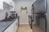 Modern kitchen with sleek black appliances, stylish white cabinetry, and elegant backsplash design.