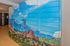 Vibrant apartment complex wall mural depicting a beautiful mountain landscape, adding a touch of natural serenity to the modern hallway.
