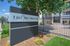 Welcome to The Monroe Apartments with elegant signage, charming landscaping, and secure fencing.