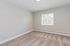 Bright and inviting room with fresh plush carpet and a large sunlit window, perfect for versatile interior design.