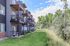 Modern apartment complex with private balconies and serene green surroundings, perfect for nature lovers.
