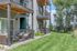 Modern apartment exterior with private balconies overlooking a lush green lawn, perfect for relaxing outdoor moments.