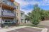 Modern apartment building exterior with elegant balconies and lush greenery, offering a serene and inviting atmosphere.