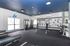 Modern fitness center with state-of-the-art equipment and vibrant decor, ideal for an energizing workout experience.