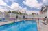 Inviting outdoor pool area with colorful lounge chairs and scenic views, perfect for relaxation and leisure.