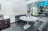Contemporary office space with sleek black bench seating and a round white table, featuring stylish decor and a large window with city map design.