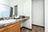 Bright, modern bathroom with elegant granite countertop, stylish sink, and charming decor accents.