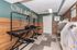 Modern pet spa with vibrant 'Oh My Dog!' sign, featuring grooming tables and wash stations, perfect for pampering your furry friends.