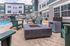 Charming apartment complex with a modern poolside patio featuring Adirondack chairs and a sleek fire pit.