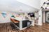 Modern communal space featuring sleek bar seating, contemporary artwork, and a coffee station with artistic decor.