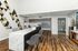 Elegant apartment lobby with a modern marble reception desk, stylish patterned wall art, and a warm wooden floor enhancing the inviting atmosphere.