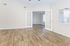 Bright, airy living space with elegant hardwood floors and double French doors, perfect for a cozy and inviting home environment.