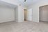 Bright and spacious room with plush carpeting, neutral walls, and ample closet space, offering a versatile and inviting living area.