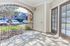 Charming apartment entrance with elegant archway and French doors, offering a warm welcome to modern living.