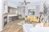 Modern living room with elegant hardwood floors, vibrant yellow sofa, and a cozy fireplace.