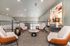 Chic loft seating area with modern armchairs and vibrant abstract art, creating a stylish and inviting ambiance.
