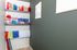 Charming storage nook with colorful gift bags on sleek shelves and vibrant wrapping paper display.