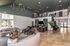 Luxurious apartment lobby featuring elegant seating areas, modern decor, and an inviting mezzanine with natural light.