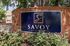 Inviting entrance to Savoy Apartments with elegant signage and lush greenery.