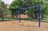 Inviting outdoor playground with dual swings, nestled amidst lush greenery, perfect for family enjoyment and relaxation.