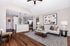 Chic living room with elegant lighting, plush seating, modern artwork, and a cozy ambiance.