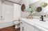 Elegant bathroom featuring modern fixtures, a marble countertop, and stylish decor with natural accents.