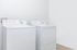 Bright laundry room with modern washer and dryer, offering sleek efficiency and convenience.