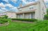 Charming townhouse with lush green lawn and private patio, perfect for enjoying the serene neighborhood.