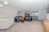 Inviting living room with plush blue sofas, modern decor, and a cozy bar area, offering a perfect space for relaxation and entertainment.