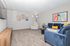 Inviting living room with plush blue sofa, modern decor, and vibrant wall art creating a cozy ambiance.