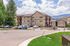 Charming residential complex with modern apartments, surrounded by scenic mountain views and lush greenery, offering ample parking and tranquil living.