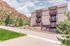 Charming apartment building with scenic mountain backdrop and inviting balconies, offering tranquil living amidst nature.