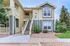 Charming modern apartment building with stylish exterior, scenic greenery, and inviting entrance.